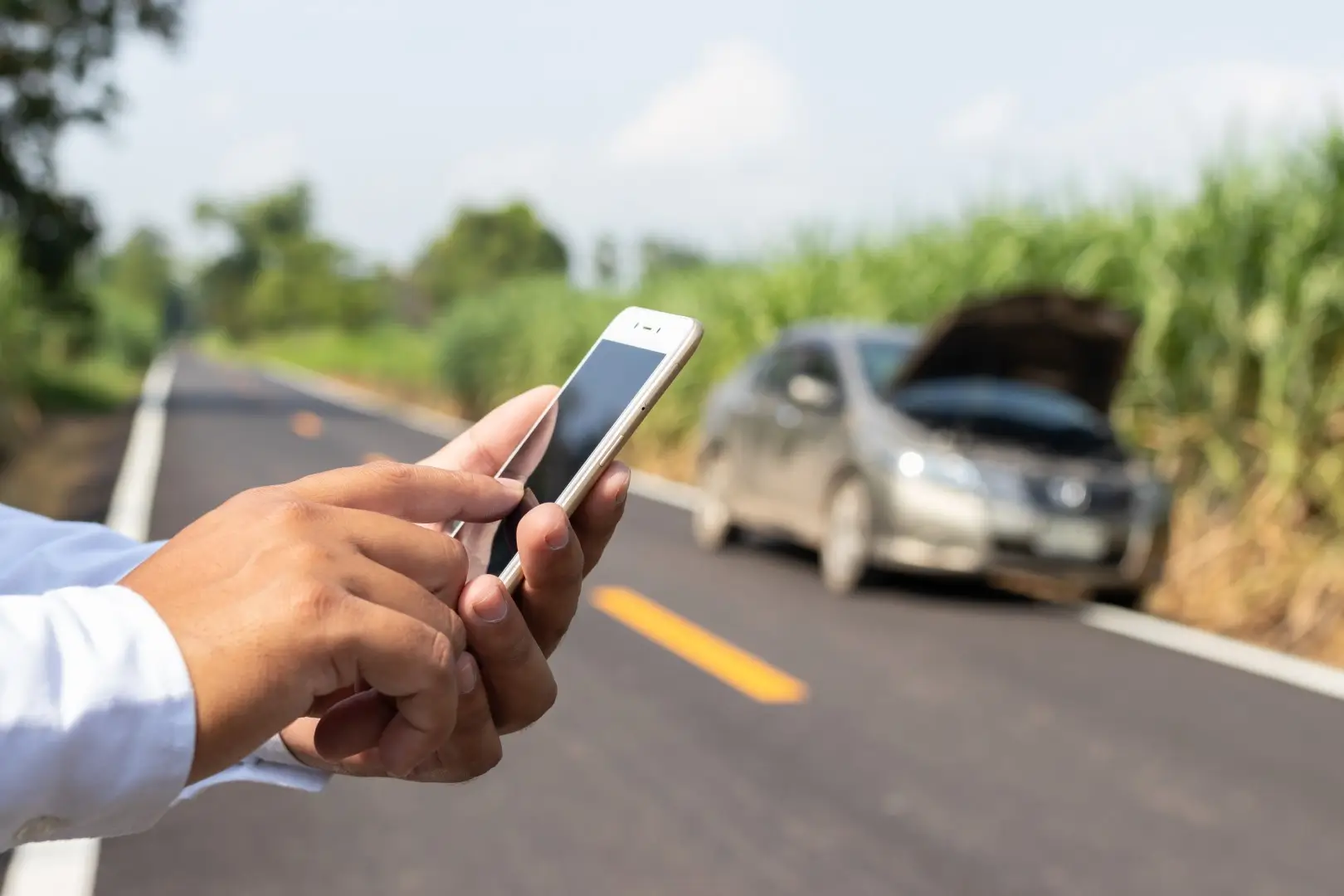 Businessman calling for assistance with his car broken.
